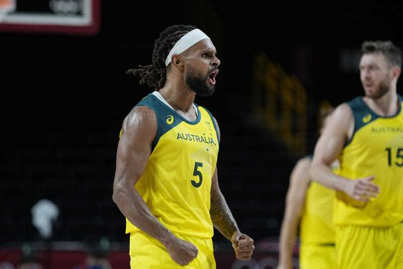 Australia's Patty Mills (5) celebrates after a score against Germany during a men's basketball preliminary round game at the 2020 Summer Olympics
