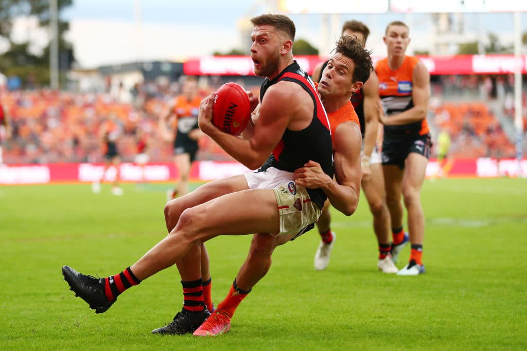 SYDNEY, AUSTRALIA - MAY 08: Josh Kelly of the Giants tackles Jayden Laverde of the Bombers during the round eight AFL match between the Greater Western Sydney Giants and the Essendon Bombers at GIANTS Stadium on May 08, 2021 in Sydney, Australia. (Photo by Mark Metcalfe/AFL Photos/via Getty Images)