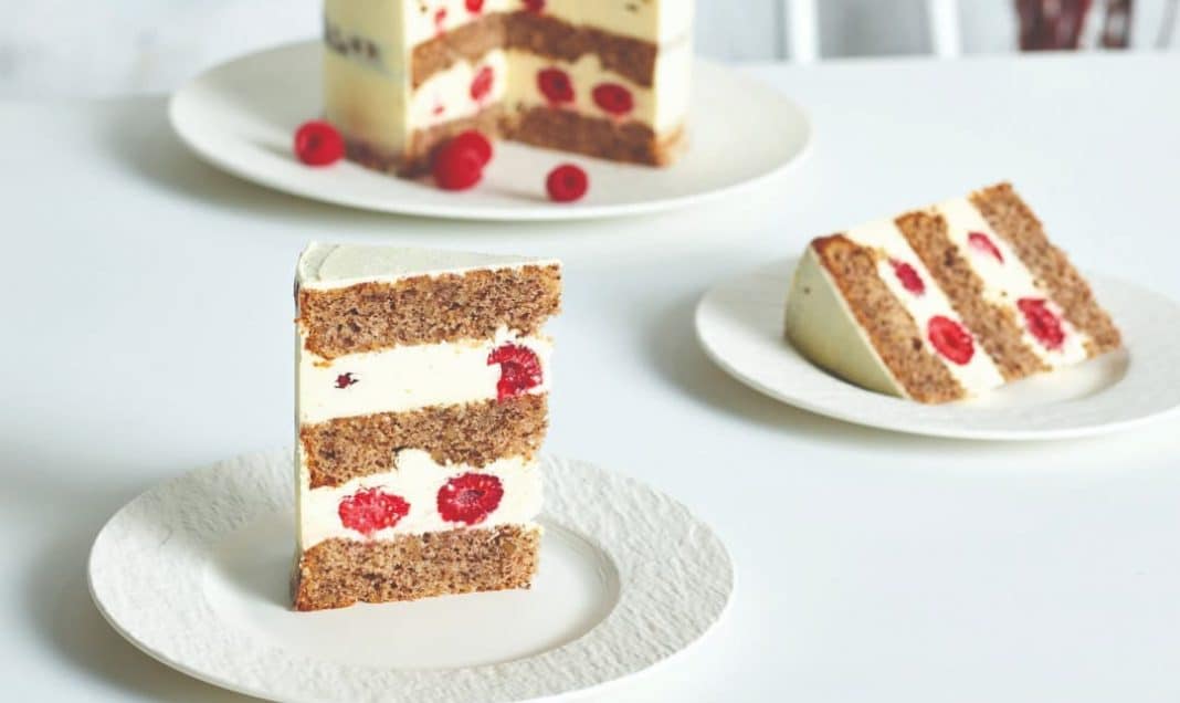 Layered walnut cake with raspberries and cream cheese vanilla frosting