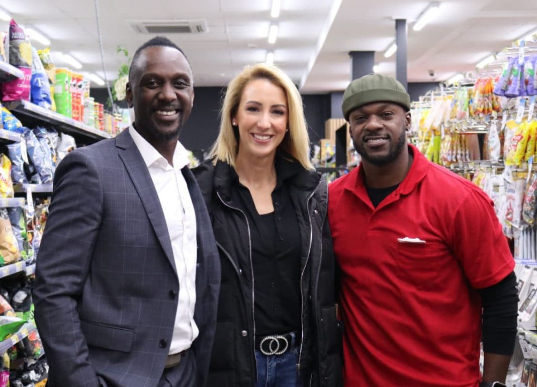 A woman and two men in a supermarket