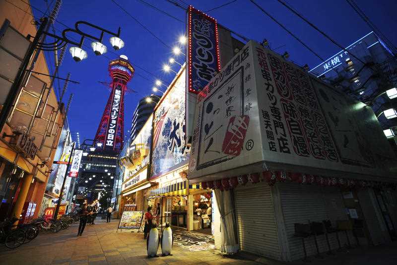 Tsutenkaku Tower is illuminated in red as the Japanese government declares a state of emergency in Osaka City amid the COVID-19 pandemic