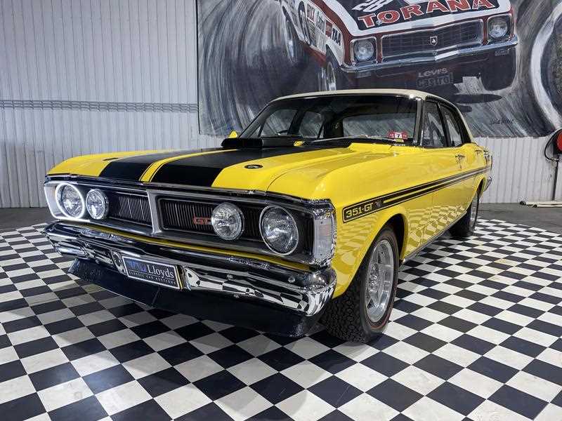 a GTHO Phase III Ford Falcon in yellow with black GT stripes