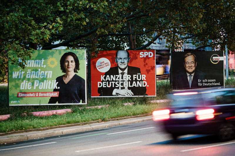 Campaigning posters of the Green party (L), the Social Democrats (C) and the Christian Democratic Union (R) show the top candidates Annalena Baerbock (L), Olaf Scholz (C) and Armin Laschet (R) in Berlin, Germany, 25 September 2021