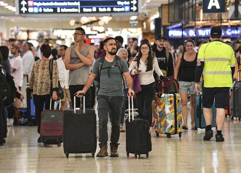 Travellers are seen at Overseas Arrivals and Departures (OAD) at Sydney's International Airport in Sydney, Monday, December 17, 2018