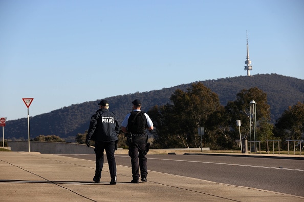 Two Australian Federal Police officers patrolling deserted streets of Canberra