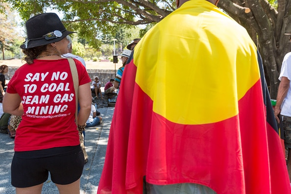 People are seen protesting against coal seam gas fracking and for traditional land rights