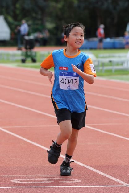 Boy participating in little athletics ACT event.