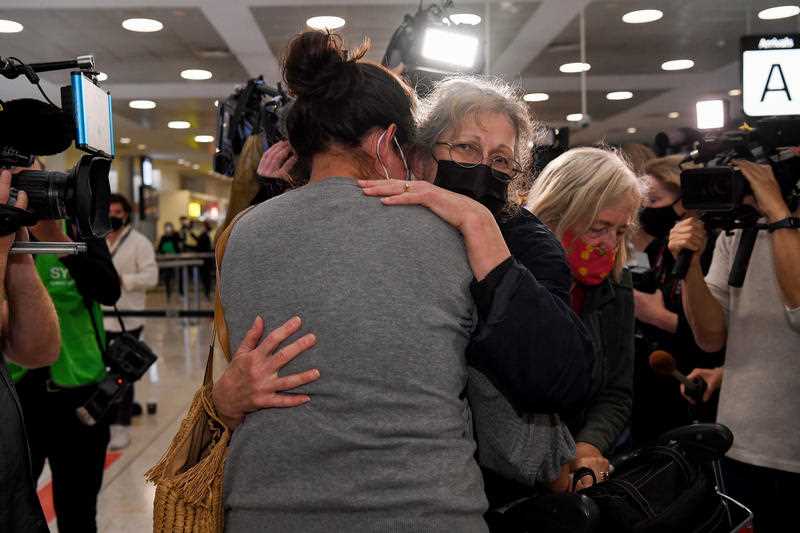 A traveller (right) arriving on one of the first international flights is greeted by her daughter at Sydney International Airport, Monday, November 1, 2021.