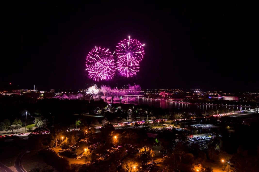 purple fireworks at night over Lake Burley Griffin in Canberra