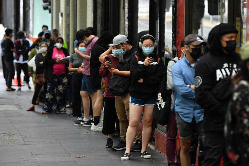 People queue at a walk-in COVID-19 testing site at in Melbourne, Wednesday, January 5, 2022.