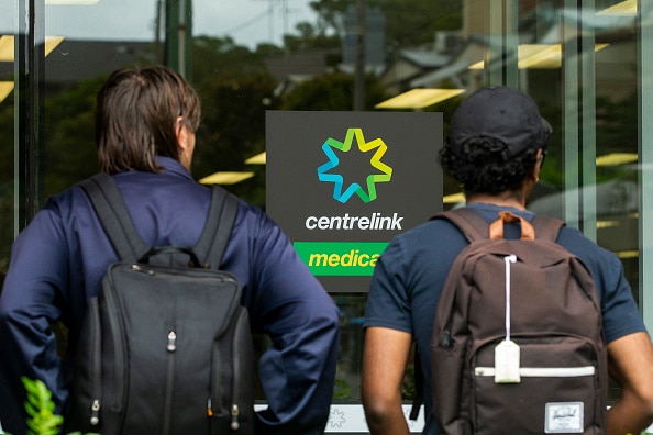 People are seen lining up at Centrelink in Bondi Junction on March 23, 2020.