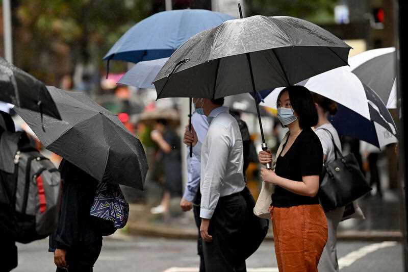 Members of the public are seen with a face mask on in Sydney, Friday, February 25, 2022