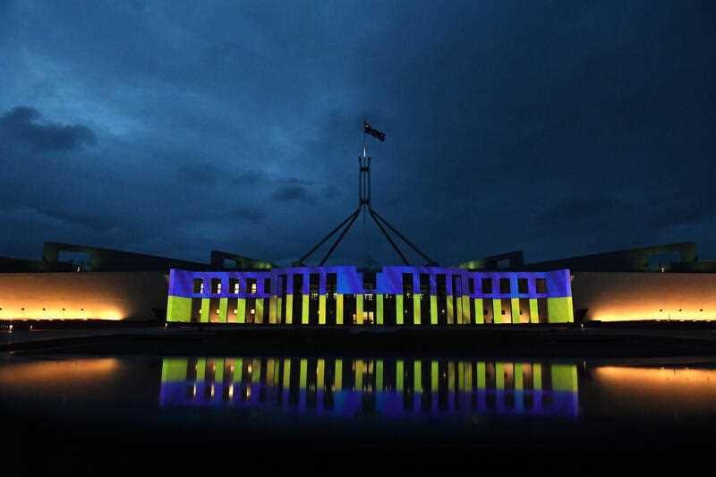 Australia’s Parliament House is illuminated with the colours of Ukraine’s flag in solidarity with the country's people and government, in Canberra, Monday, February 28, 2022