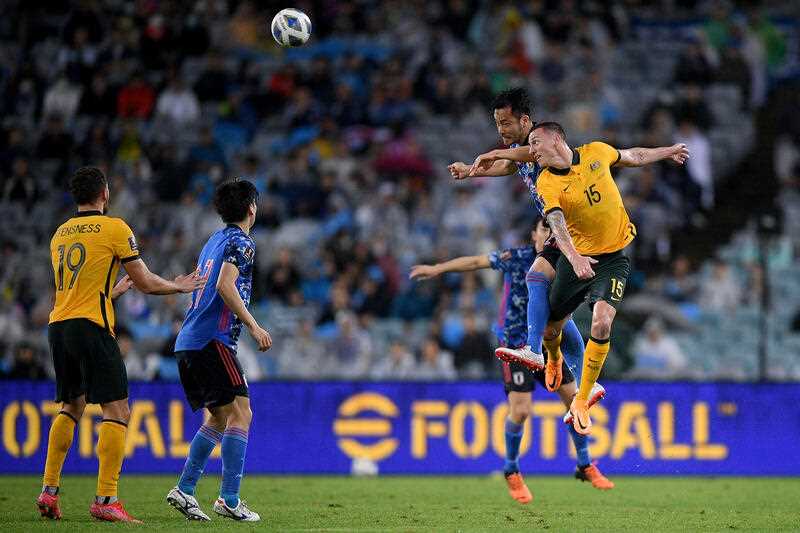 Mitchell Duke of the Socceroos competes to head the ball with Maya Yoshida of Japan during the AFC Asian Qualifier match between Australia and Japan at Accor Stadium in Sydney, Thursday, March 24, 2022.