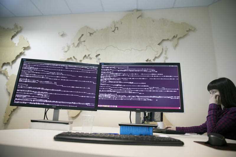 A computer code is seen on displays in the office of Global Cyber Security Company Group-IB in Moscow, Russia,