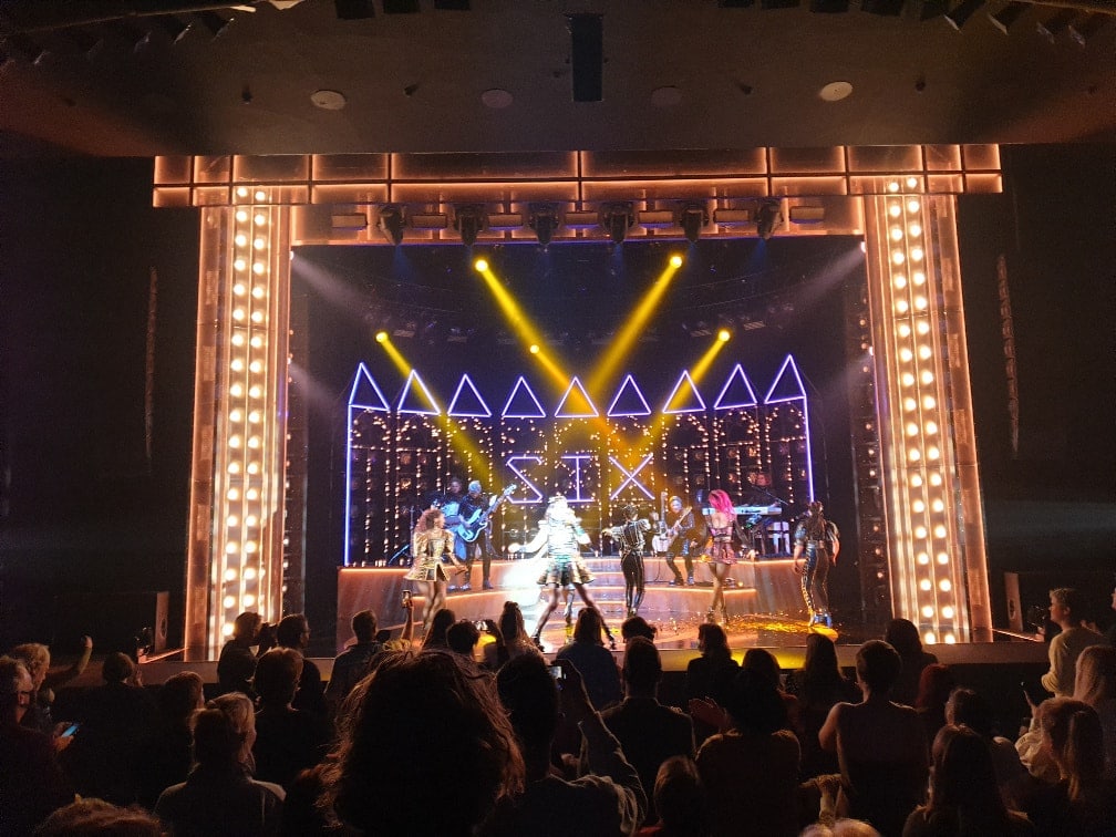 6 female singers and 4 musicians are seen on stage during Six the musical at Canberra Theatre