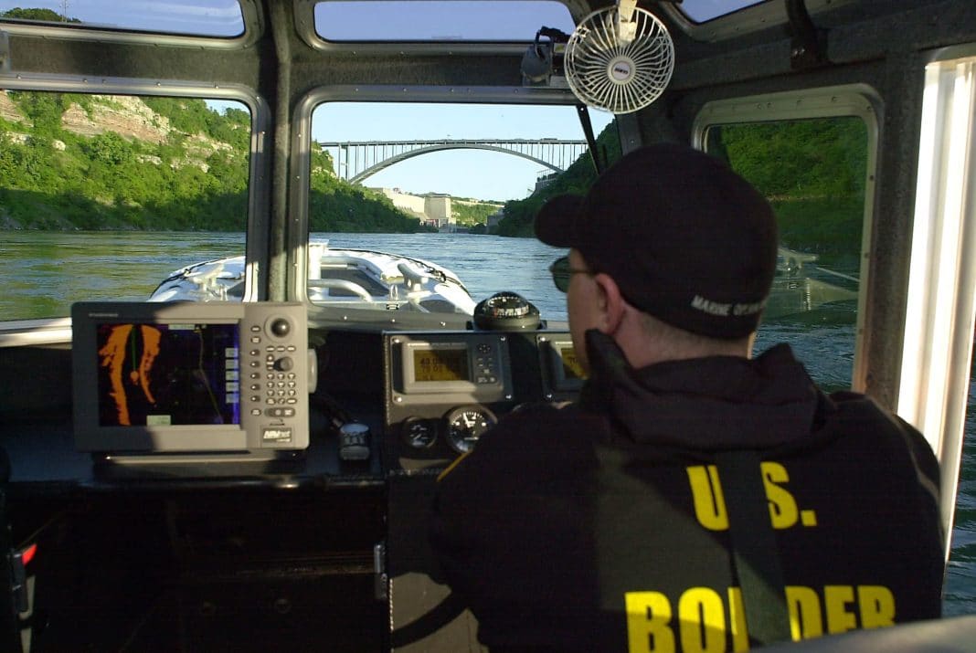 U.S. Border Patrol Agent Phil Knapp navigates the patrol boat up the lower Niagara River towards the Lewiston-Queenston international crossing