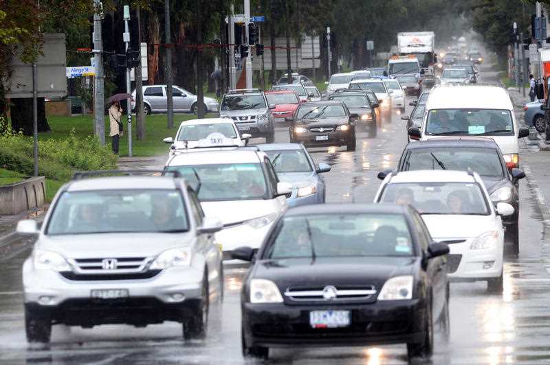 cars seen driving in Canberra in the rain