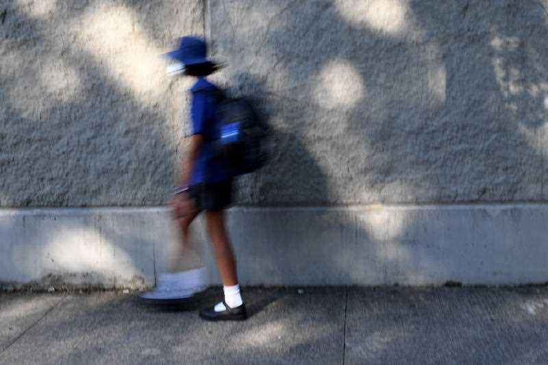 a primary school student is seen returning to school in Sydney in February 2022