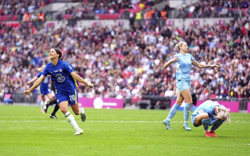 Chelsea's Sam Kerr, left, celebrates scoring their side's third goal of the game as Manchester City players look dejected, during the Women's FA Cup final soccer match between Chelsea and Manchester City, at Wembley Stadium, London, Sunday, May 15, 2022