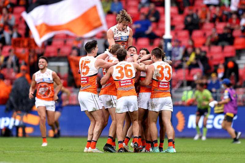 Jacob Wehr of the Giants celebrates kicking a goal with team mates during the AFL Round 10 match between the GWS Giants and the West Coast Eagles at Giants Stadium in Sydney, Sunday, May 22, 2022