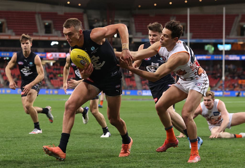SYDNEY, AUSTRALIA - JUNE 19: Patrick Cripps of the Blues is tackled by Josh Kelly of the Giants during the round 14 AFL match between the Greater Western Sydney Giants and the Carlton Blues at GIANTS Stadium on June 19, 2021 in Sydney, Australia. (Photo by Mark Kolbe/Getty Images)