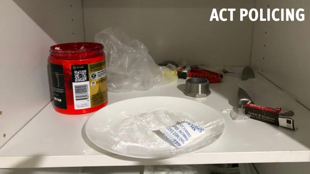 white powder and drug paraphernalia seen in a cupboard