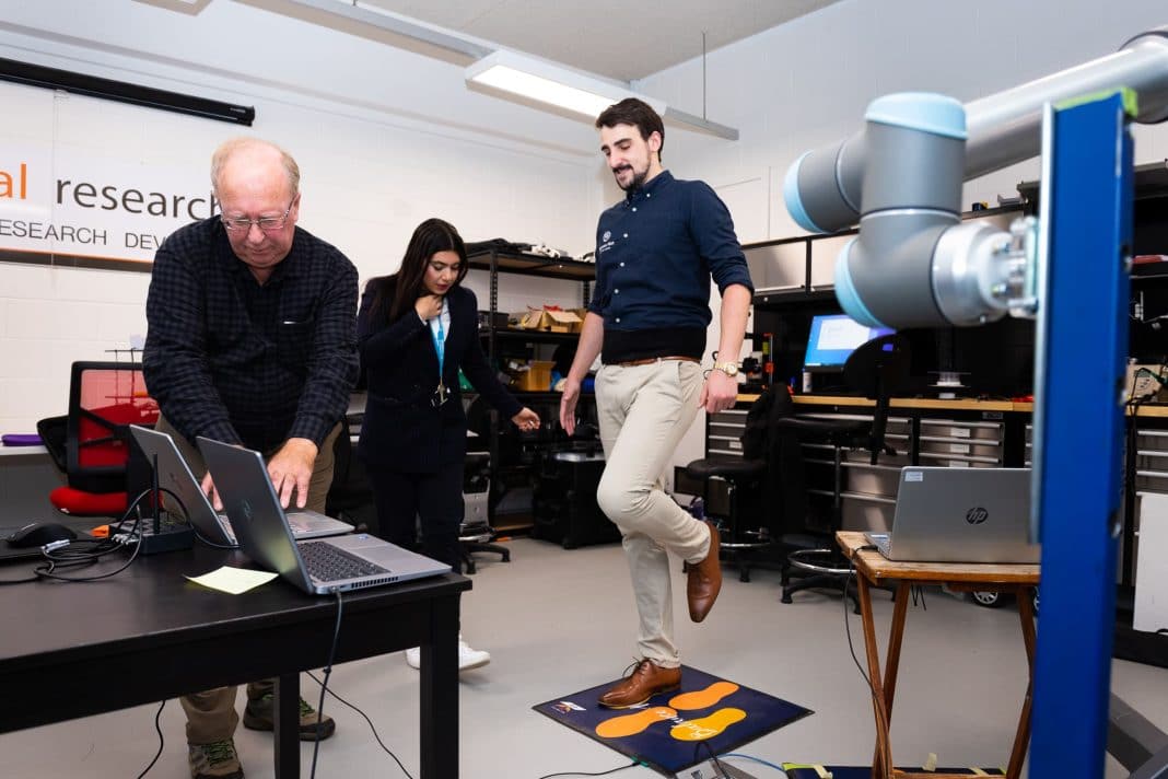 3 people in a university lab testing a balance mat