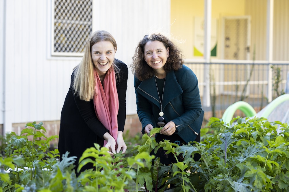 Amanda Tobler, CEO of Community Services #1, and Rebecca Vassarotti MLA, ACT Minister for the Environment, in the community garden. Photo: Kerrie Brewer.
