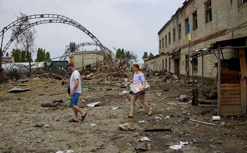 Local workers take their belongings from a wood factory after a recent rocket attack on the outskirts of the small city of Bezlyudovka in the Kharkiv area, Ukraine, 03 June 2022