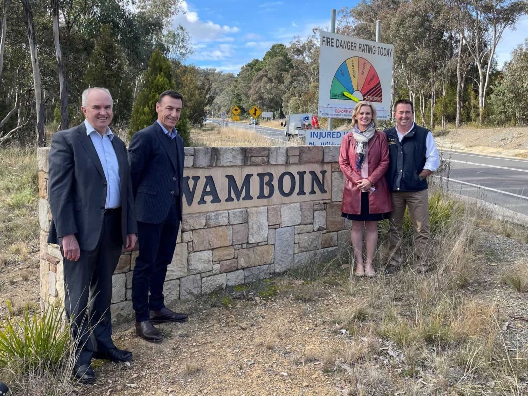 3 man and 1 woman standing near Wamboin sign
