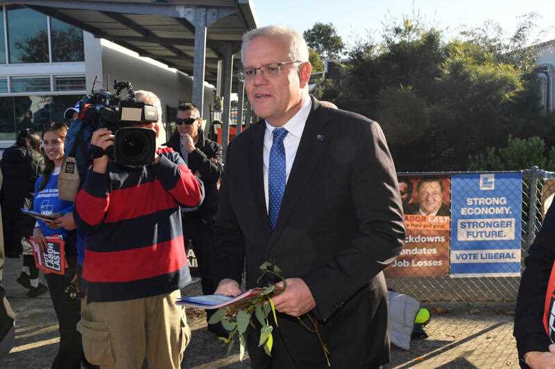 Prime Minister Scott Morrison with how to vote cards at the Laurimar Primary School on Federal Election day, in Doreen the seat of McEwen in Melbourne’s north, Saturday, May 21, 2022.
