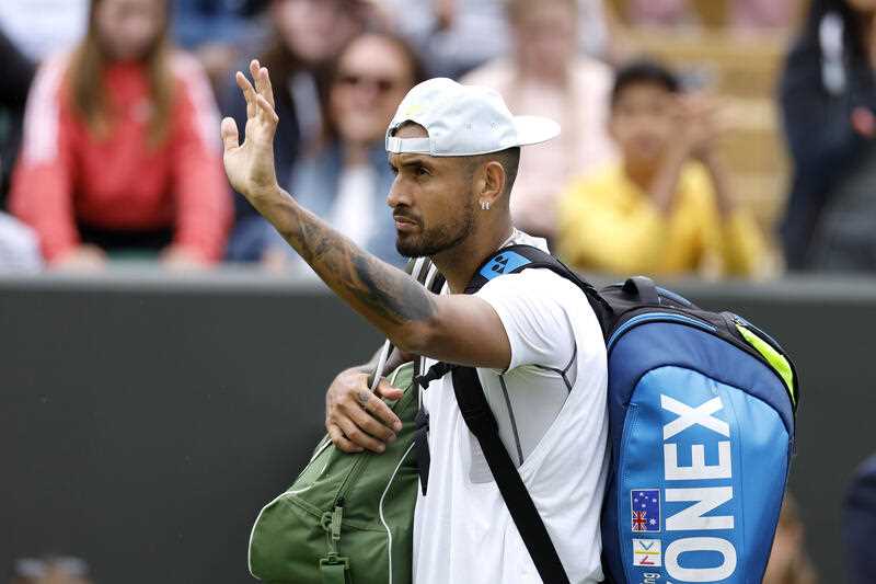 Australia's Nick Kyrgios waves as he leaves the court after beating Serbia's Filip Krajinovic, in a second round men's single match on day four of the Wimbledon tennis championships in London, Thursday, June 30, 2022