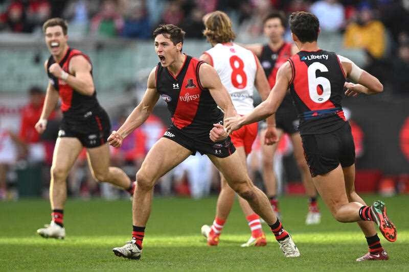 Jake Kelly of Essendon celebrates kicking a goal during the AFL Round 16 match between the Essendon Bombers and the Sydney Swans at the Melbourne Cricket Ground in Melbourne, Saturday, July 2, 2022