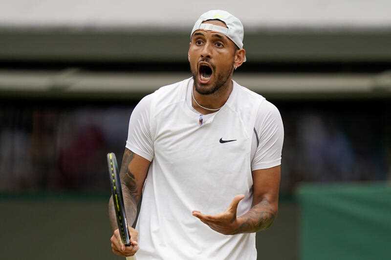 Nick Kyrgios reacts during a men's singles quarterfinal match against Chile's Cristian Garin on day ten of the Wimbledon tennis championships in London, Wednesday, July 6, 2022