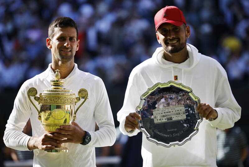 Winner Novak Djokovic (L) of Serbia and runner-up Nick Kyrgios of Australia during the award ceremony after their men's final match at the Wimbledon Championships, in Wimbledon, Britain, 10 July 2022.
