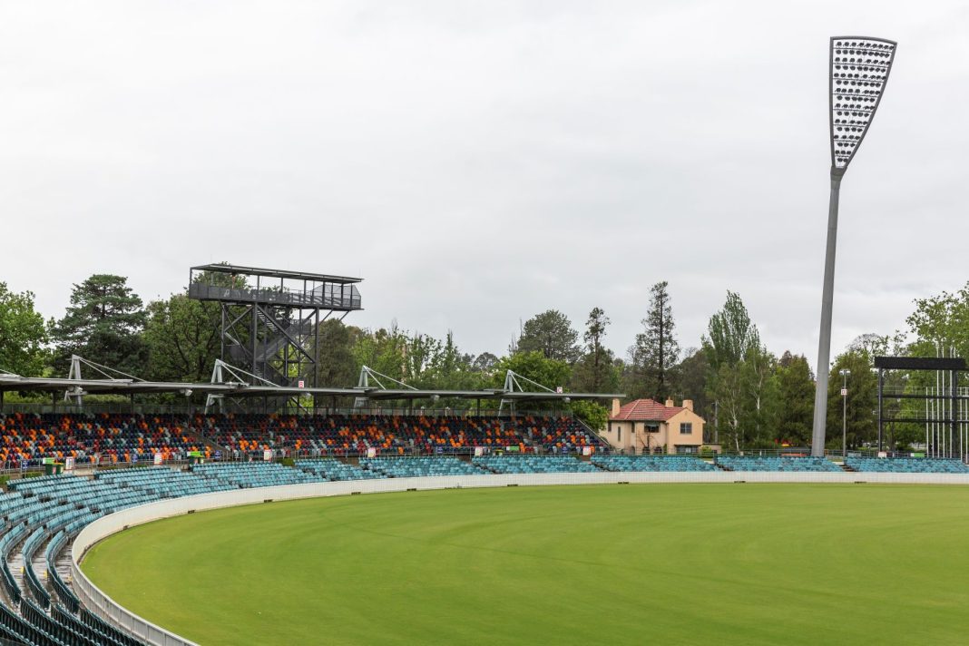 part of the grounds, seating, a stadium light and historic groundkeepers cottage is seen at Manuka Oval, Canberra