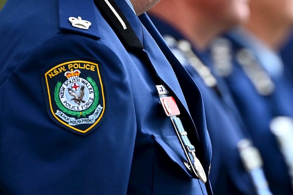 close-up of NSW police badges seen on uniforms