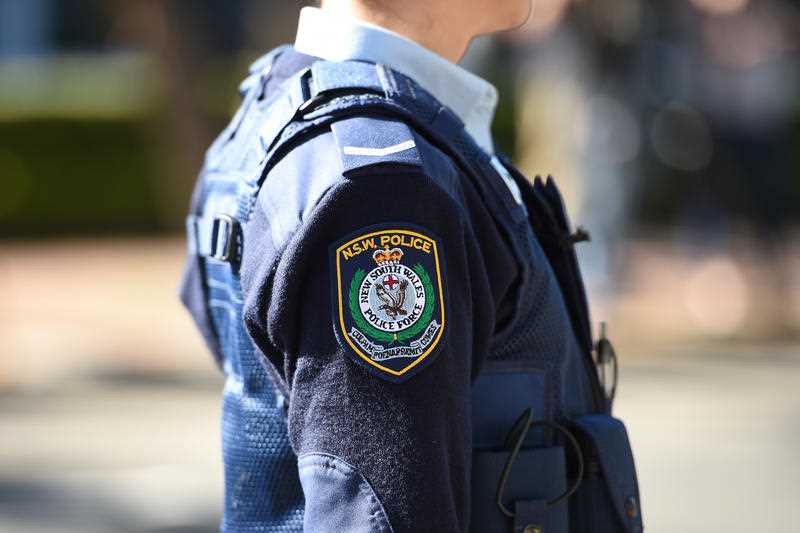 a NSW Police badge is seen on an officer's uniform