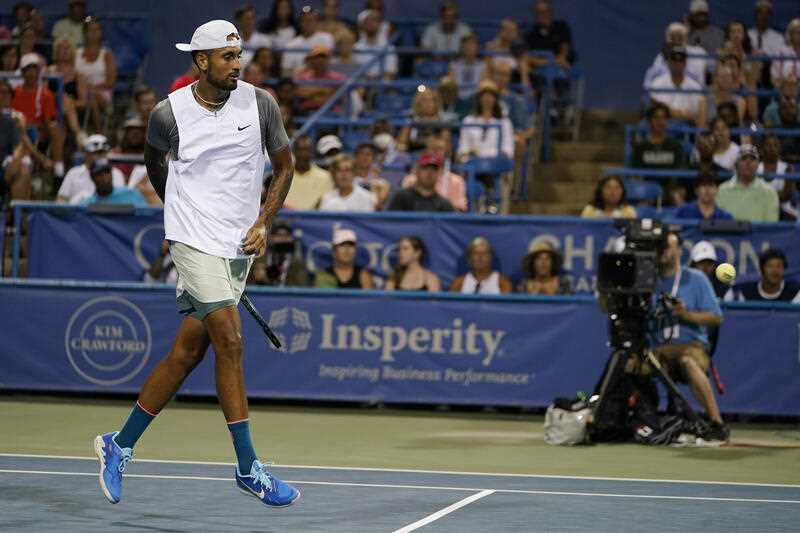 Nick Kyrgios, of Australia, hits a ball behind his back during a match against Tommy Paul, of the United States, at the Citi Open tennis tournament in Washington, Wednesday, Aug. 3, 2022