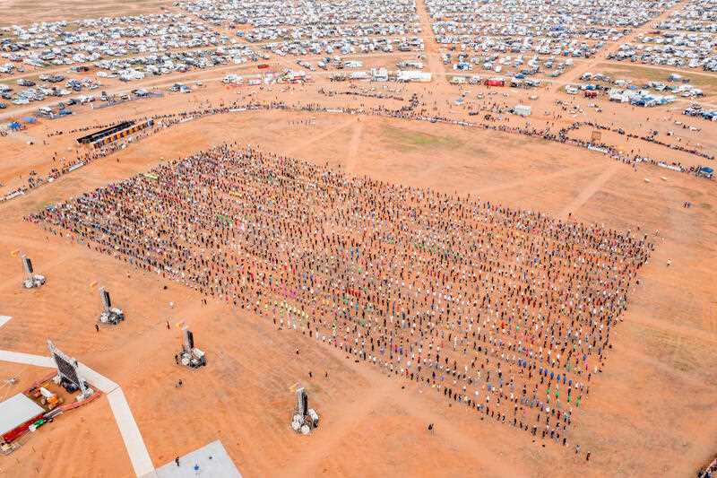 A drone image of 3000 people dancing Nutbush at an outback NSW music festival