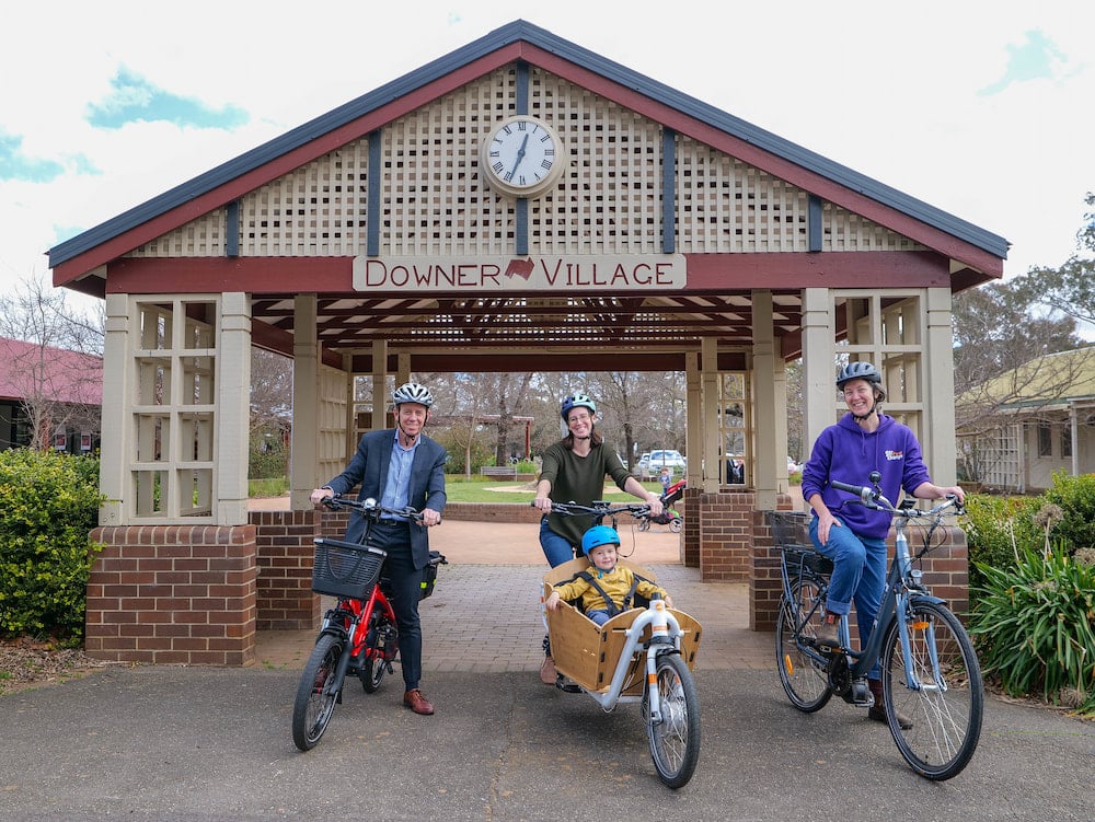 Shane Rattenbury, Minister for Emissions Reduction; bike library participant Maree Wright and her son Tom; and Brook Clinton, executive officer of SEE-Change. Photo: ACT Government