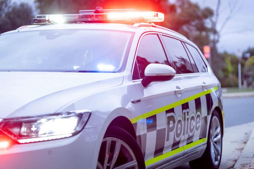 white ACT Policing station wagon with flashing lights