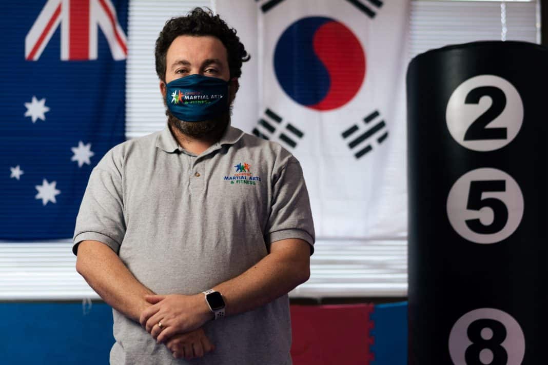 man wearing face mask in martial arts studio