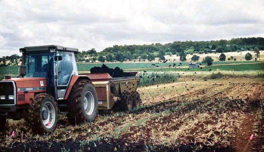 a tractor spreading treated sewage in an experiment to use biosolids to help crop production in the Kingaroy area north west of Brisbane