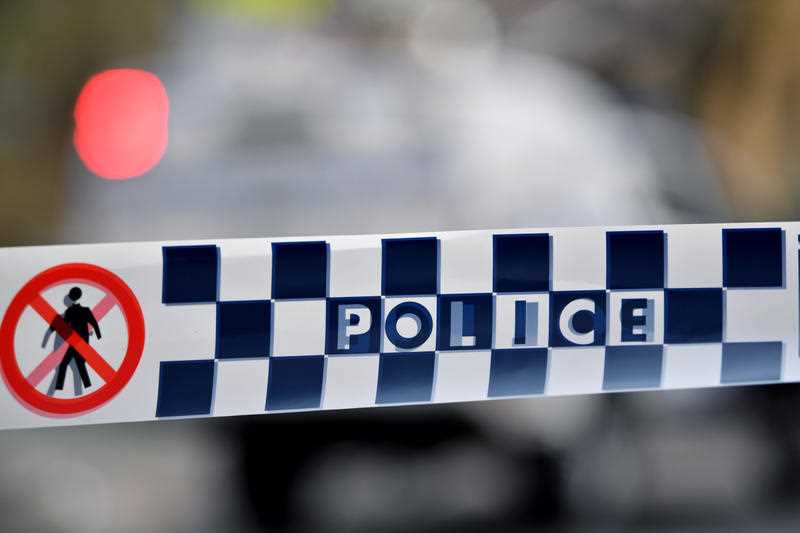 blue and white check NSW Police tape restricts access to a street