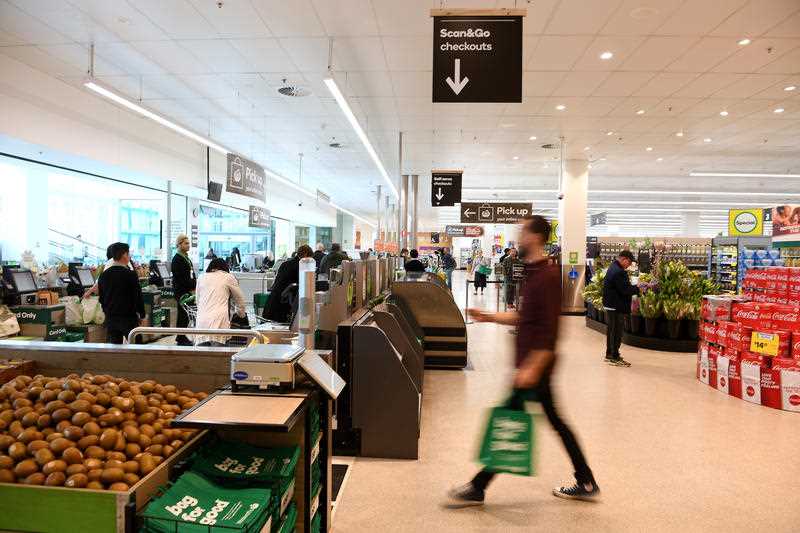 Shoppers are seen near the checkouts at a Woolies supermarket in Australia