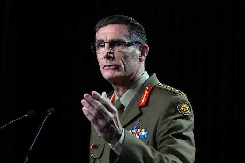 Chief of the Australian Defence Force General Angus Campbell is seen in army uniform speaking at a podium