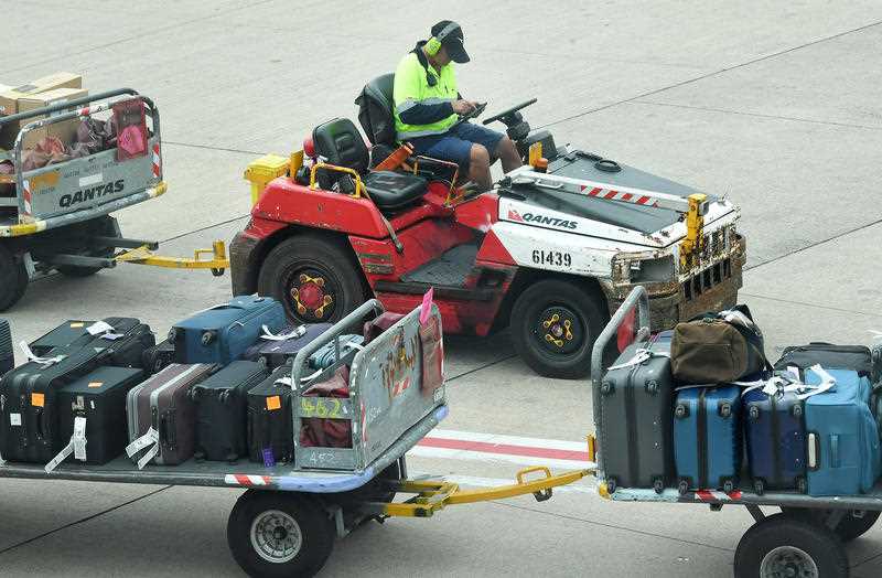 A Qantas baggage handler is seen at the Brisbane Domestic Airport