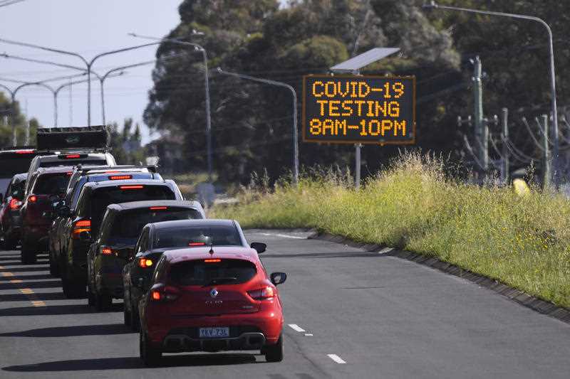 Cars line up near a Drive Through COVID-19 testing site in the suburb of Mitchell in Canberra, Wednesday, December 22, 2021